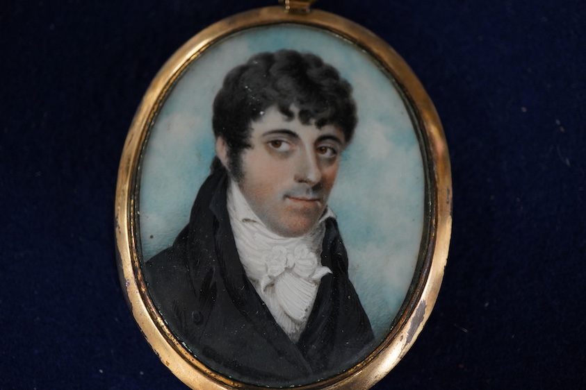 Regency School, Portrait miniature of a young gentleman wearing a frock coat, oval watercolour on ivory, 6 x 4.5cm, housed in a gilt metal pendant frame CITES Submission reference K7AFBZFN